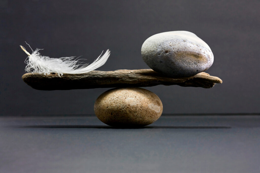 stone and feather balancing
