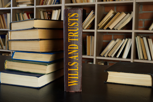 legacy planning, law book about wills and trusts on the desk.